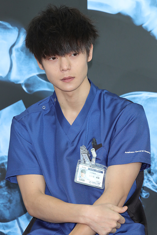 放射線技師役の衣装で。細マッチョな二の腕をのぞかせて