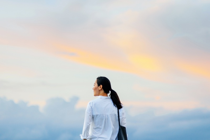 夕焼けの空と女性