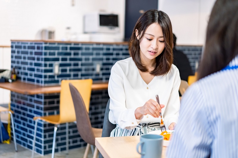 同僚とランチをしている女性