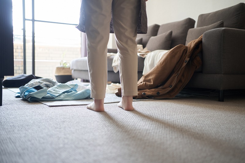 散らかった部屋と女性