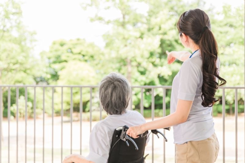 車椅子を押す女性