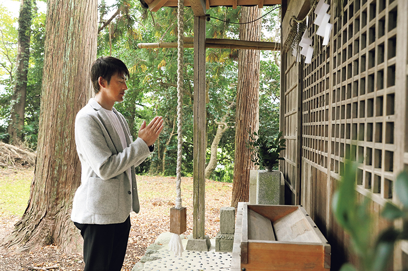 神社に手を合わせる男性