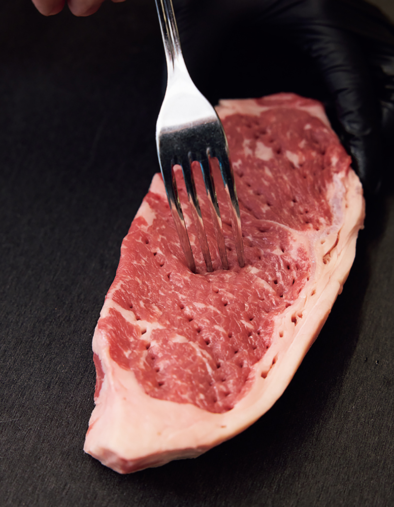 フォークを刺して筋繊維を断ち切る（撮影／鈴木泰介）