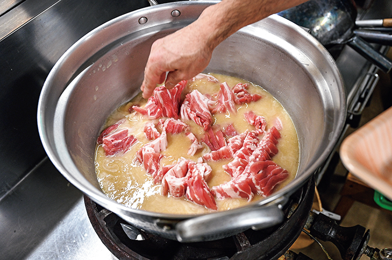 豚肉を鍋に入れている